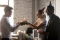 Diverse colleagues congratulating workmate with birthday giving cake with candle Royalty Free Stock Photo