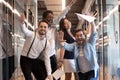 Funny multiethnic employees posing for picture in office hallway Royalty Free Stock Photo