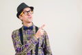 Funny nerd pointing finger away at copy space. Smiling young nerdy in glasses showing your product. Nerd man in plaid shirt and Royalty Free Stock Photo