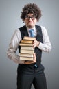 Funny nerd student is hiolding books