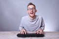 Funny nerd young businessman, man working on computer.Typing on the keyboard programmer in glasses in front of computer Royalty Free Stock Photo