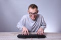 Funny nerd young businessman, man working on computer.Typing on the keyboard programmer in glasses in front of computer Royalty Free Stock Photo
