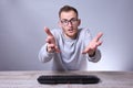 Funny nerd young businessman, man working on computer.Typing on the keyboard programmer in glasses in front of computer Royalty Free Stock Photo