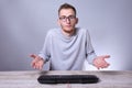 Funny nerd young businessman, man working on computer.Typing on the keyboard programmer in glasses in front of computer Royalty Free Stock Photo