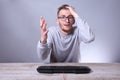 Funny nerd young businessman, man working on computer.Typing on the keyboard programmer in glasses in front of computer Royalty Free Stock Photo