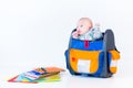 Funny newborn baby in a school backpack