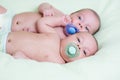 Funny newborn baby twins lying one next other