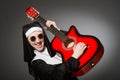 The funny nun with red guitar playing Royalty Free Stock Photo