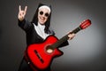 The funny nun with red guitar playing Royalty Free Stock Photo