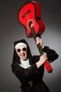 The funny nun with red guitar playing Royalty Free Stock Photo