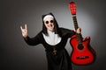 The funny nun with red guitar playing Royalty Free Stock Photo