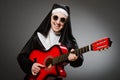 The funny nun with red guitar playing Royalty Free Stock Photo