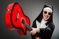 The funny nun with red guitar playing Royalty Free Stock Photo