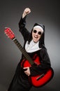 The funny nun with red guitar playing Royalty Free Stock Photo