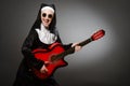 The funny nun with red guitar playing Royalty Free Stock Photo