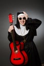 The funny nun with red guitar playing Royalty Free Stock Photo