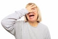 Funny old lady closes her eyes with her hand, peeps and laughs,  on white Royalty Free Stock Photo