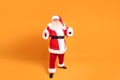 Funny old Santa Claus on yellow studio background. Merry Christmas and Happy New Year! Copy space. Xmas sale, discount concept Royalty Free Stock Photo