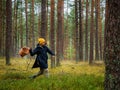 Funny one person searching for a mushrooms in an autumn deep forest. mushroomer with a basket in a woods