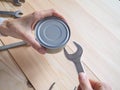 Funny opening tinned food. Funny geek girl trying to easy open a tin can with a wrench and pliers.