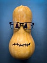 Funny pumpkin with glasses on dark background Royalty Free Stock Photo