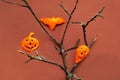 Funny orange figurines for Halloween on beige background. Holidays in the Time of COVID. Creative copy space