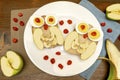 Funny owl face sandwich toast bread with chicken eggs, apple, banana, dried berry fruits on plate. Cute kids childrens baby`s Royalty Free Stock Photo