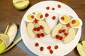 Funny owl face sandwich toast bread with chicken eggs, apple, banana, dried berry fruits on plate. Cute kids childrens baby`s Royalty Free Stock Photo