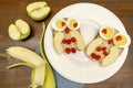 Funny owl face sandwich toast bread with chicken eggs, apple, banana, dried berry fruits on plate. Cute kids Royalty Free Stock Photo