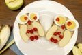 Funny owl face sandwich toast bread with chicken eggs, apple, banana, dried berry fruits on plate. Cute kids Royalty Free Stock Photo