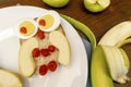 Funny owl face sandwich toast bread with chicken eggs, apple, banana, dried berry fruits on plate. Cute kids Royalty Free Stock Photo