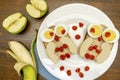 Funny owl face sandwich toast bread with chicken eggs, apple, banana, dried berry fruits on plate. Cute kids Royalty Free Stock Photo