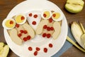 Funny owl face sandwich toast bread with chicken eggs, apple, banana, dried berry fruits on plate. Cute kids childrens baby`s Royalty Free Stock Photo