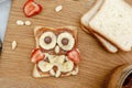 Funny owl face sandwich toast bread with peanut butter, banana, strawberry on wooden board. Cute kids childrens baby\'s sweet Royalty Free Stock Photo