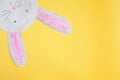 funny paper bunny with long ears on a yellow background