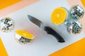 Funny party. Disco balls and mirror cut ball with orange fruit inside. Top view, flat lay. Kitchen knife and orange cut Royalty Free Stock Photo