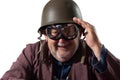 Funny pensioner with helmet and pilot goggles saluting