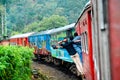 Funny people travelling on the footboard of the train to badulla, srilanka