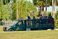 Funny person giving food to a giraffe, during safari tour at Bush Gardens Tampa Bay Theme Park.