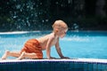 Photo of active baby having fun in swimming pool Royalty Free Stock Photo