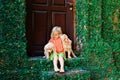 Funny photo of child cuddling beautiful golden labrador retriever puppy