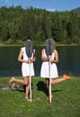 Funny photo on vacation. Two girls in white dresses are hiding behind the oars