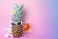 Funny pineapple with cocktail, plumeria flowers and starfish on color background, space for text. Summer party Royalty Free Stock Photo
