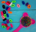 Funny Pink baby hairbrush and multicolored rubber bands for hair Royalty Free Stock Photo