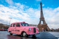 Funny pink car Marc Jacobs parked in Paris with Eiffel tower in the background. Royalty Free Stock Photo