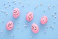 Funny pink eggs with face feeling on blue background Royalty Free Stock Photo