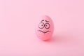 Funny pink eggs with face feeling on colorful background Royalty Free Stock Photo