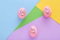 Funny pink eggs with face feeling on colorful background Royalty Free Stock Photo