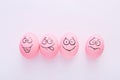 Funny pink eggs with face feeling on white background Royalty Free Stock Photo