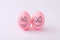 Funny pink eggs with face feeling on white background Royalty Free Stock Photo